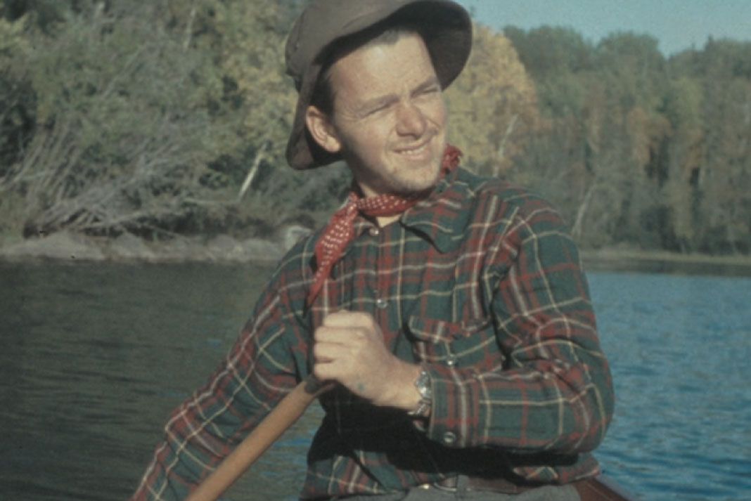 artist and filmmaker Bill Mason paddles a canoe