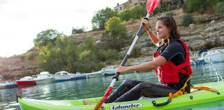 Woman paddles an Islander Hula sit-on-top kayak