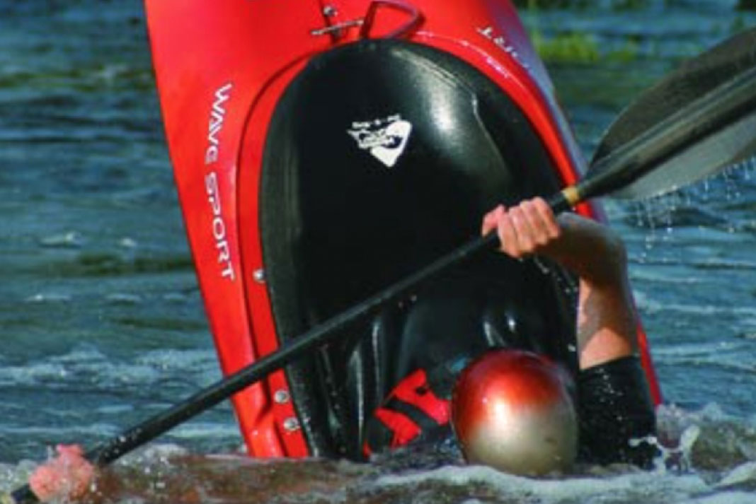 Person goes vertical in a WaveSport Super EZ whitewater kayak