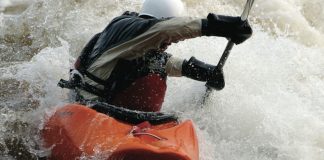 A person kayaks in whitewater in the Bliss-Stick RAD kayak
