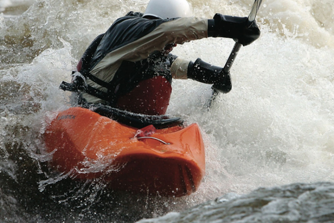 A person kayaks in whitewater in the Bliss-Stick RAD kayak