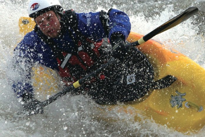 man paddles in Pyranha S6F freestyle kayak