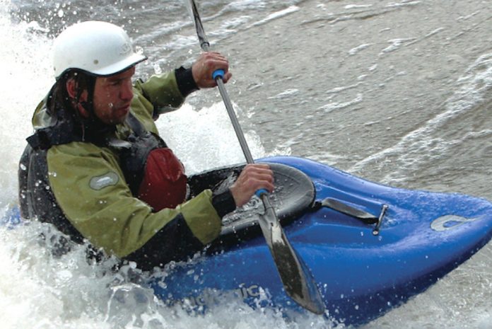 Man whitewater kayaking in a Liquidlogic Big Wheel kayak