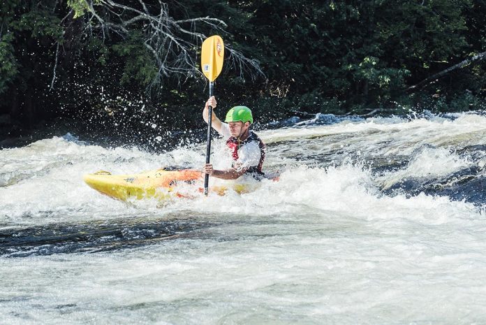 Man whitewater kayaking