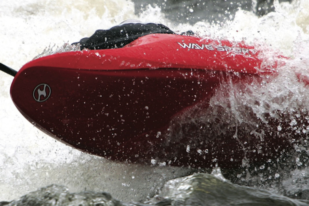 The WaveSport ZG kayak surfing through whitewater