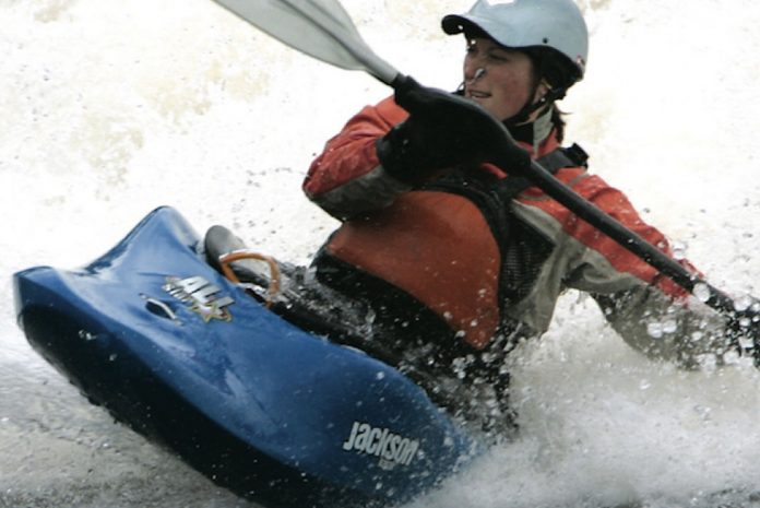 Man paddles in whitewater in the Jackson Kayak All-Star freestyle boat
