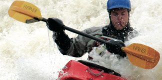 Man paddles a Dagger Crazy 88 kayak through crashing whitewater