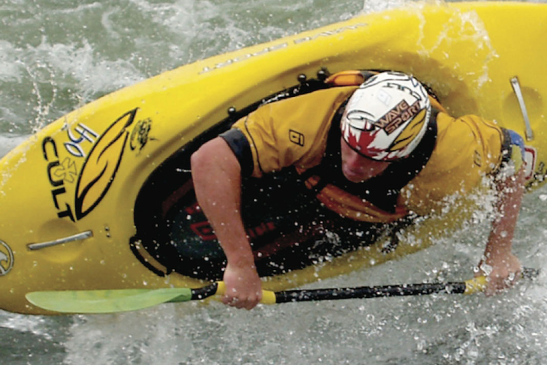 Man paddling a WaveSport Project freestyle kayak in whitewater