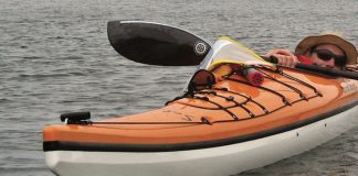 Man fits almost entirely inside the Solstice GT Titan kayak by Current Designs