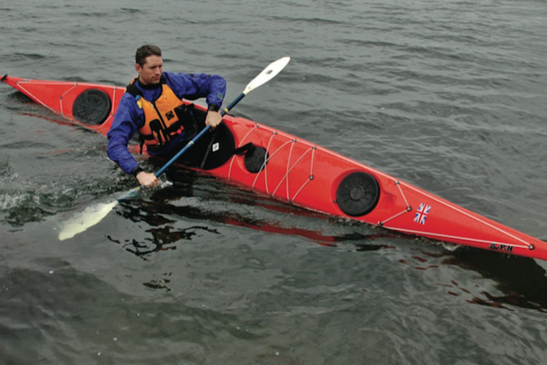 Man demonstrates paddling in a P&H Cetus kayak