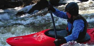Woman whitewater kayaking in Wave Sport Diesel kayak
