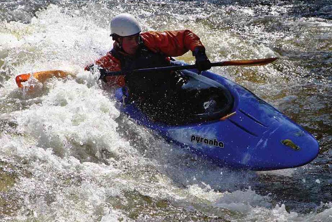 Man paddling a Pyranha Z.One kayak through whitewater