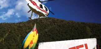 helicopter takes off towing kayaks in search of the best kayaking in new zealand