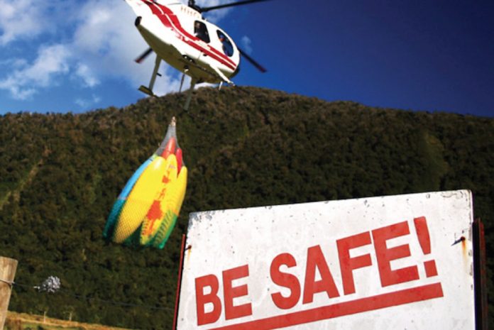 helicopter takes off towing kayaks in search of the best kayaking in new zealand