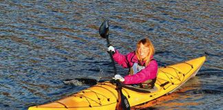 Woman paddles a Delta 16 kayak