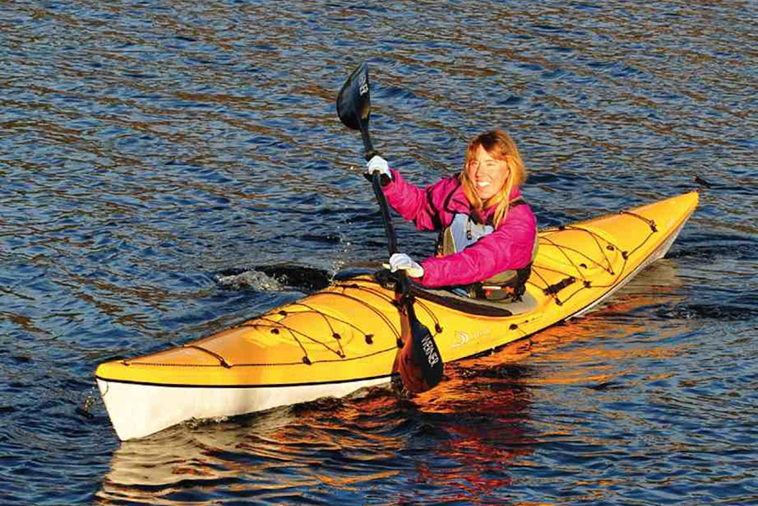 Woman paddles a Delta 16 kayak