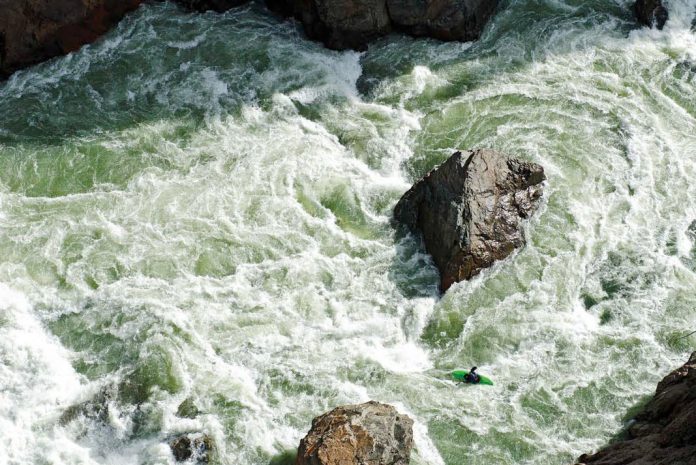 View from above of kayaker in whitewater
