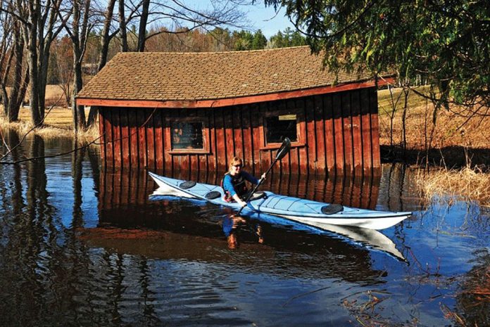 Woman paddles a Nigel Dennis Pilgrim Expedition kayak