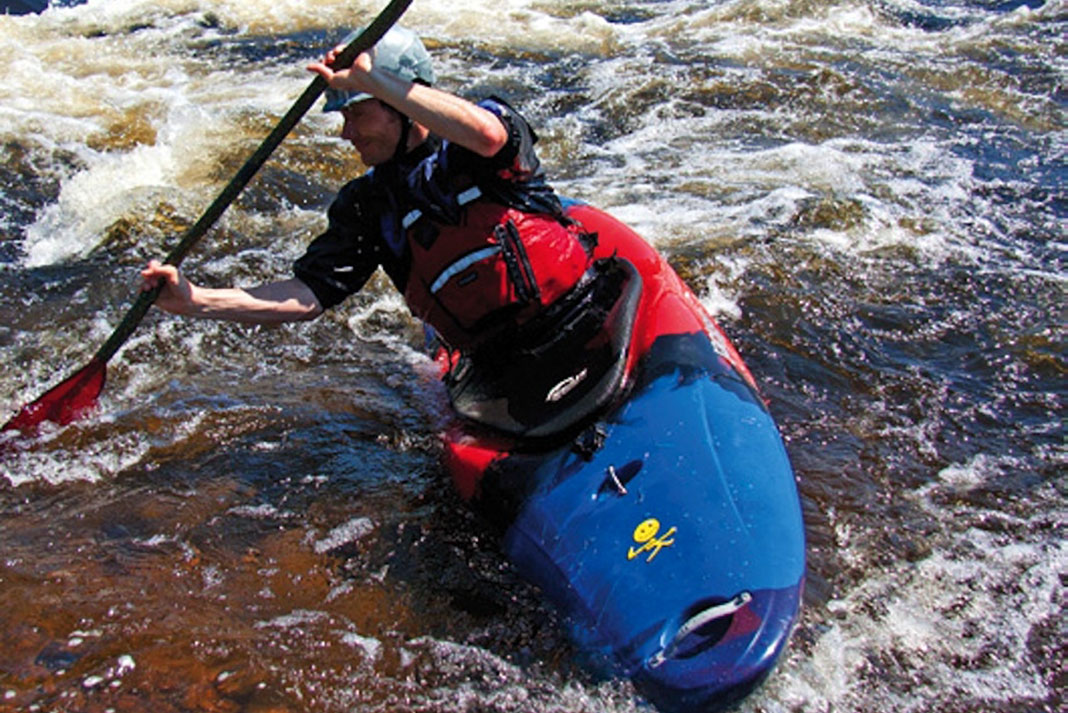 Man kayaking down a river in a Jackson Zen kayak