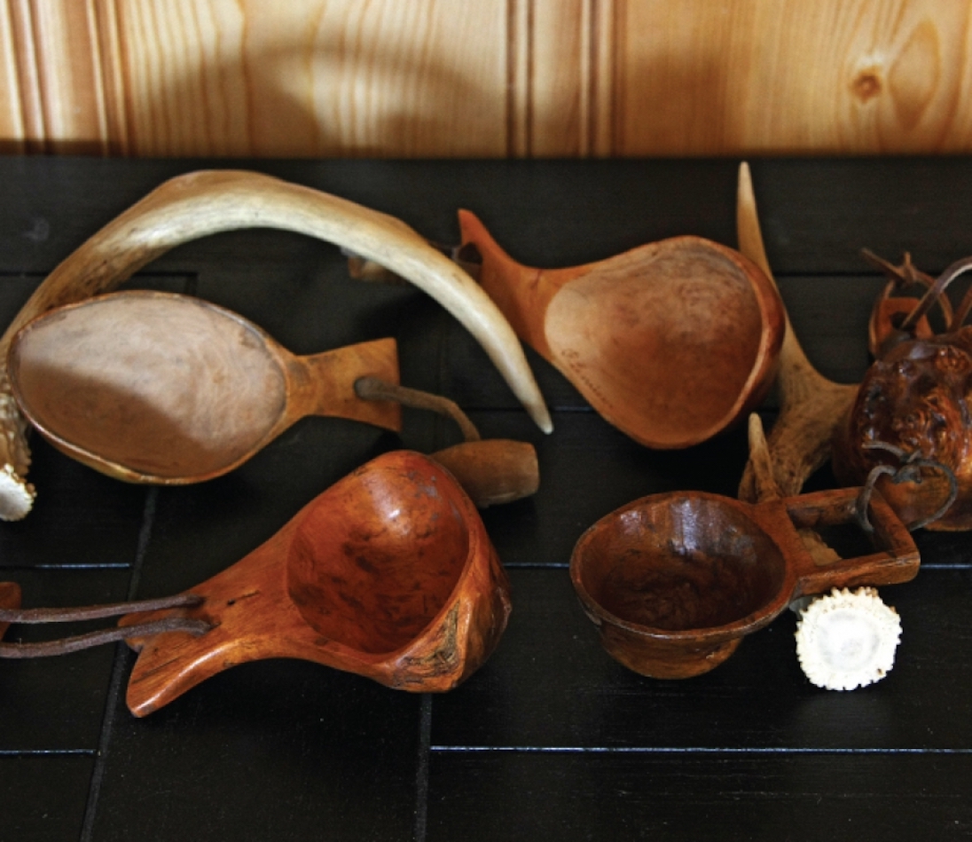 Hand-carved canoe cups sitting on a table.