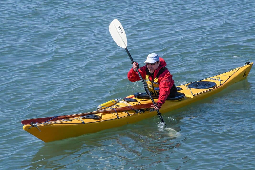 Man paddling yellow kayak