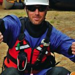 14 Expert-Tested Ideas For Customizing Your Open Boat Male paddler sits in front of two canoes giving thumbs-up and thumbs-down hand signals.