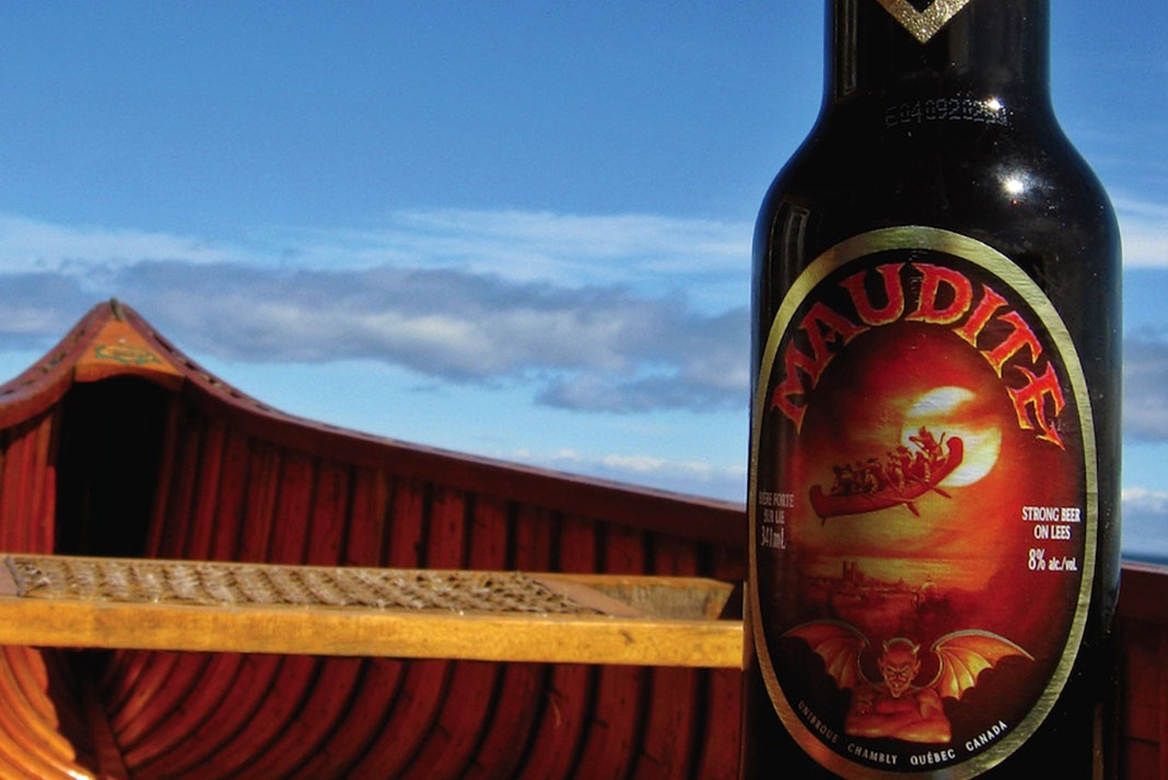 A bottle of Maudite beer resting on a canoe