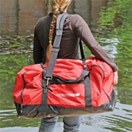 Woman carrying red duffel bag.