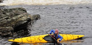 Woman paddles the Delta 15S kayak