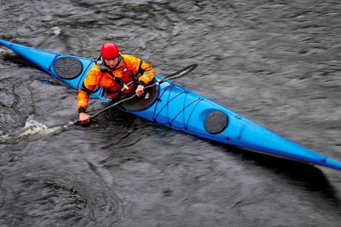 Man in blue sea kayak