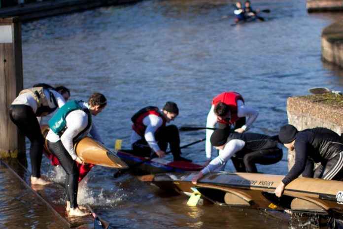 Marathon canoe racers practise their racing techniques
