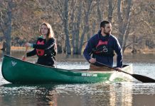 Man and woman paddle in a Nova Craft Bob Special canoe