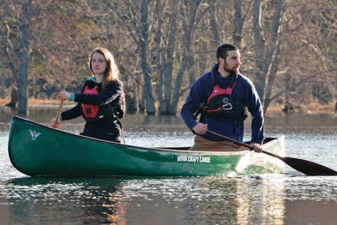 Man and woman paddle in a Nova Craft Bob Special canoe