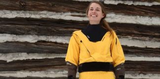 Woman wearing yellow and black drysuit