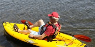 Man sits on yellow inflatable pedal-drive kayak