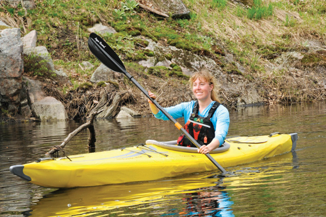 Woman paddling yellow kayak