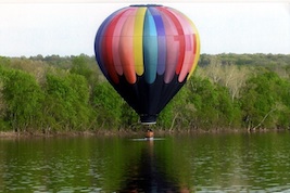 Hot air balloon landing on a river