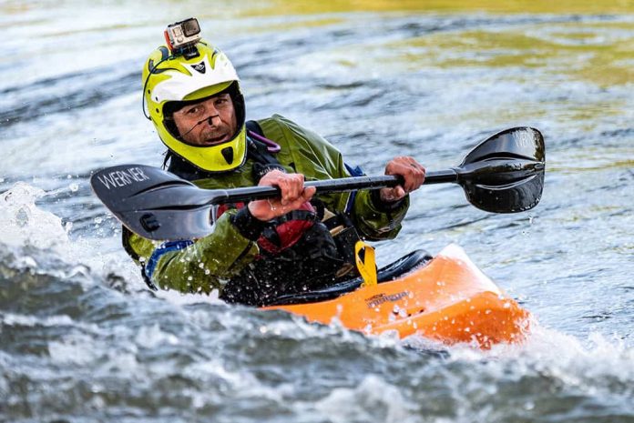 Man kayaking and wearing GoPro on his hlmet