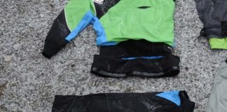 Pieces of green and black drysuit on the ground