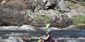 Man paddles the Dagger Roam 9.5 sit-on-top kayak in rapids