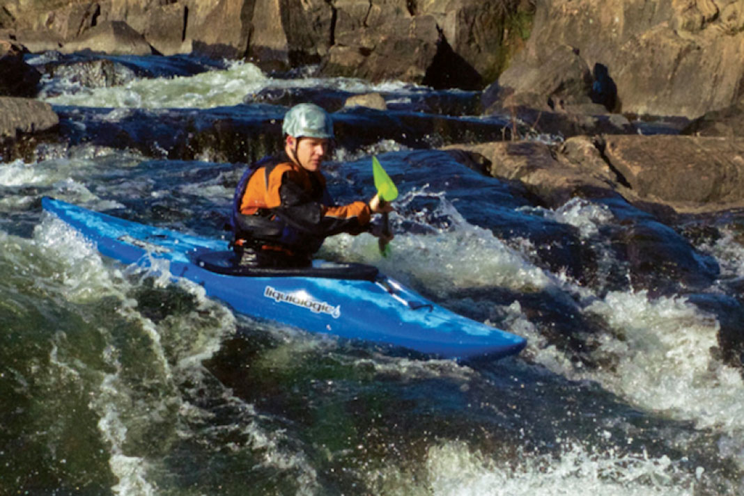 Man paddles through rapids in a Liquidlogic Braaap whitewater kayak