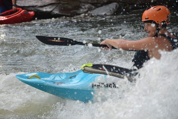 Man paddling whitewater kayak