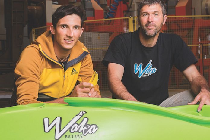 Sam Sutton and Kenny Mutton of Waka Kayaks pose in front of a Waka boat