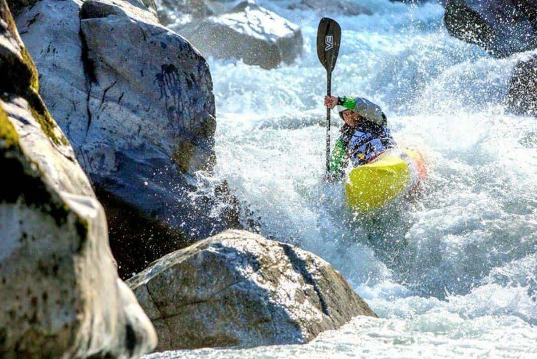 Man kayaking down river 