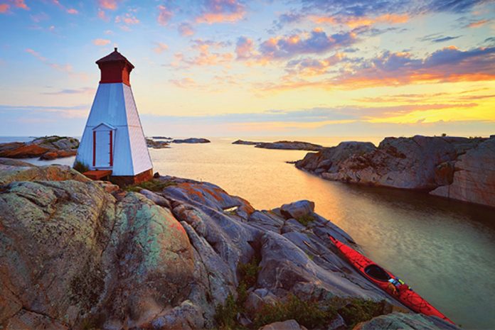Taking a break at a lighthouse from kayaking Georgian Bay