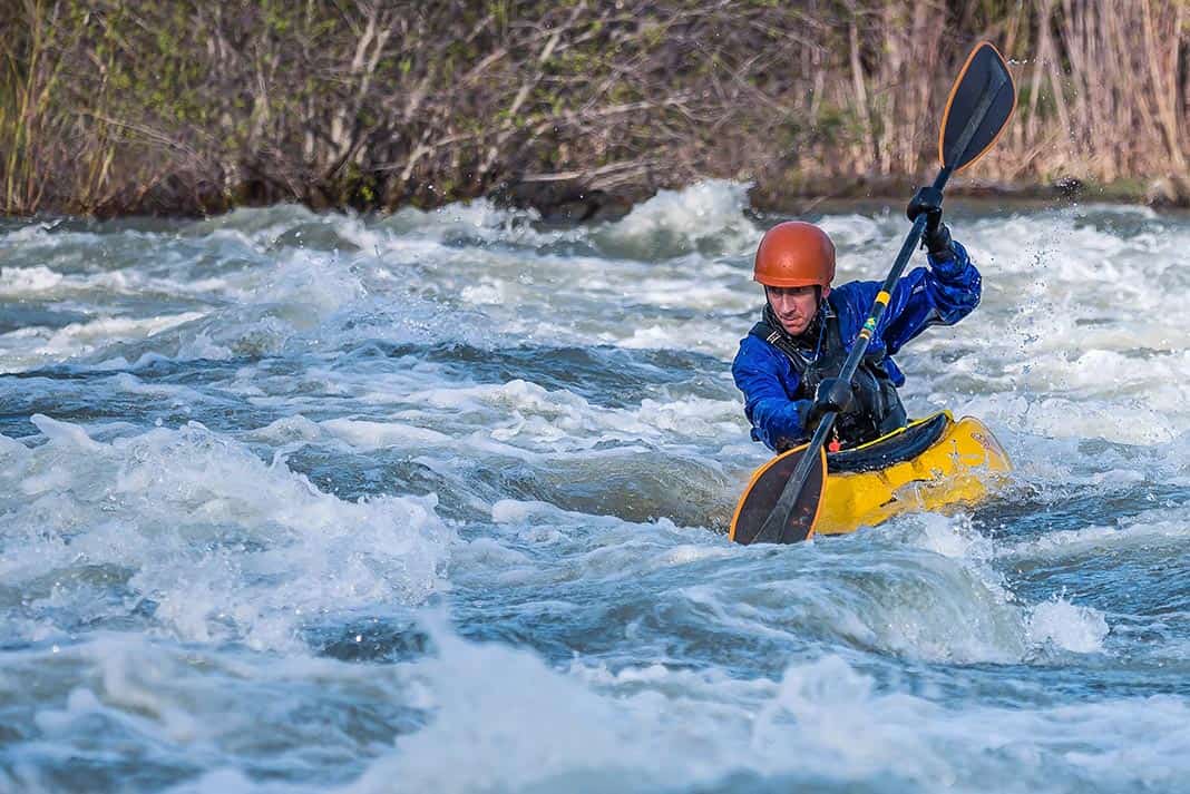 Man whitewater kayaking