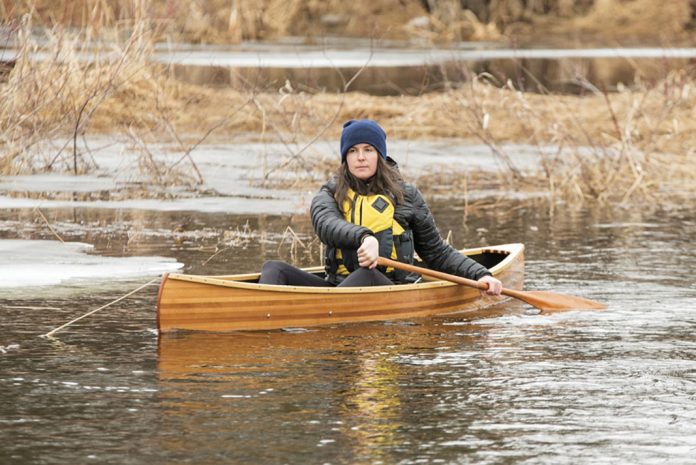 Woman paddling the Vallinga Vuntut 10 solo pack canoe