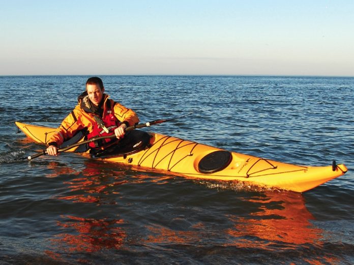 Man paddling in a Boreal Design Baffin touring sea kayak