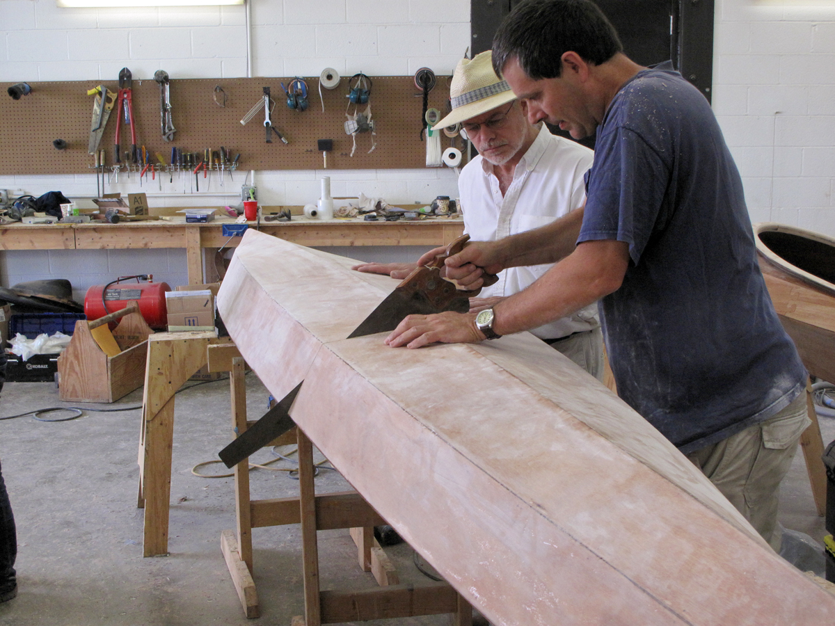 Two men work on assembling the Chesapeake Light Craft Shearwater 14 Sectional kayak