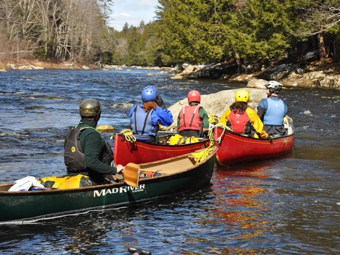group of canoeists learn how to read whitewater